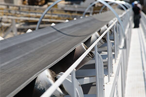 Conveyor belt with technicians in the background