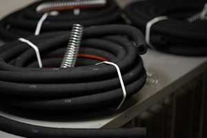 Black industrial hoses on a table